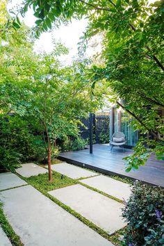 an outdoor patio surrounded by trees and plants