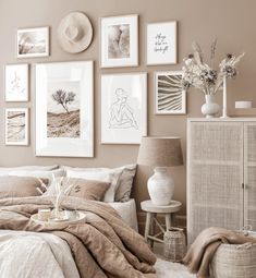 a bedroom with many pictures on the wall above it and a bed covered in blankets