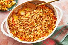 a casserole dish filled with food next to a bowl full of other foods