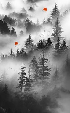 two red balloons are floating in the air above some foggy trees and pine trees