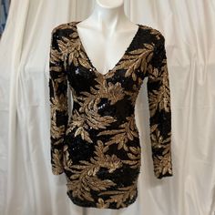 Black And Gold Sequined Floral Dress - Opened Back 100% Polyester Includes Spare Button (On Fabric Tag) Bust: 33.5 (Inch) Waist: 25 (Inch) Hips: 35.5 (Inch) Sleeves Length: 27 (Inch) Sleeves Width: 10.4 (Inch) To 9.4 (Inch) At Wrist Dress Length (From Shoulder To Bottom Of Dress): 33 (Inch) Make Me An Offer! Long Sleeve Sequin Dresses For Going Out, Gold Floral Dress, Fabric Tags, Gold Floral, Dresses Black, Black And Gold, Floral Dress, Dress Length, 4 Inch