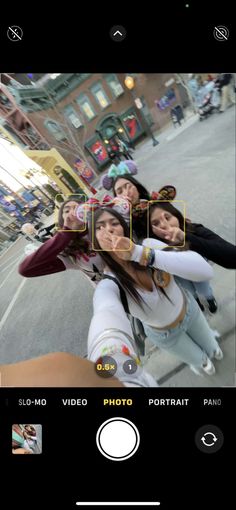 a group of people taking a selfie in the street