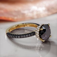 two black and white diamond rings sitting on top of a table next to each other