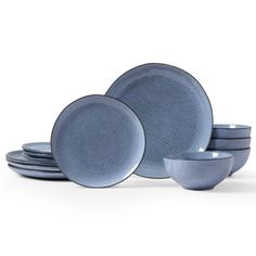 a set of four blue dishes on a white background