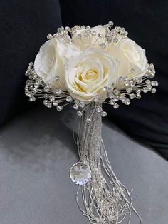 a bridal bouquet with white roses and pearls