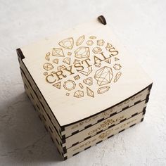 a wooden box with the word crystal carved into it's lid on a white surface