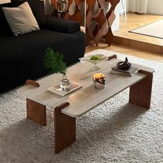 a living room with a couch, coffee table and other items on the carpeted floor