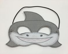 a mask with a shark's mouth and teeth on the face is made out of felt