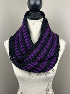 a purple and black knitted cowl on a mannequin