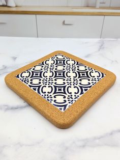 a white counter top with a blue and white tile design on the front of it