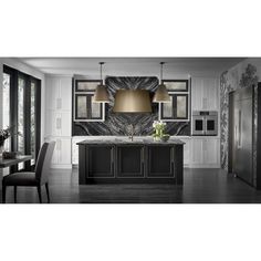 a large kitchen with black cabinets and marble counter tops, along with an island in the middle