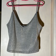 Forever 21 Women’s Silver Sparkly Top Size: Medium 68% Polyester, 16% Rayon, 13% Metallic Yarn, 3% Spandex/Elastane Condition: Never Used, Very Good Condition Casual Party Tops With Built-in Bra, Forever 21 Fitted Trendy Tank Top, Trendy Fitted Tank Top By Forever 21, Trendy Fitted Tank Top Forever 21, Forever 21 Tank Top For Night Out In Spring, Forever 21 V-neck Party Crop Top, Forever 21 Sleeveless Crop Top For Party, Forever 21 Sleeveless Party Crop Top, Forever 21 Sleeveless Crop Top For Night Out