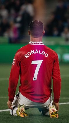 a man sitting on top of a soccer field