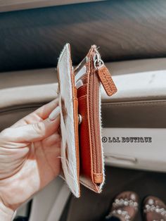 a person holding an open wallet in their hand