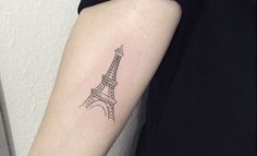 a woman's arm with a small tattoo of the eiffel tower