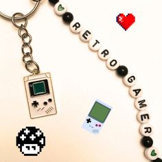 a keychain with an old school video game charm attached to it's side