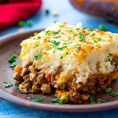 a close up of a plate of food with mashed potatoes and meat on it