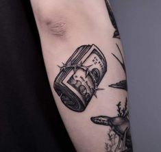 a man with a tattoo on his arm has an open can of beer in it