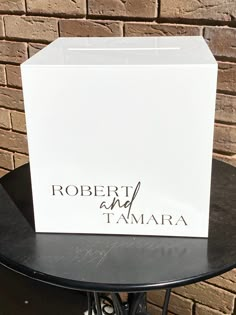 a white box with the name robert and tamara on it sitting on a table