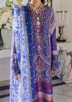 A multi-color Mughal Resham with an exquisite flower pattern on a French blue base and a delicately embroidered side kali. This style comes with a pair of pants and a beautiful ethnic chintz digitally printed dupatta in monotones of French blue. A great statement piece that will keep you looking stylish throughout the season. Shirt Front Center Panel Dyed & Embroidered on Lawn Shirt Side Kali Dyed & Embroidered on Lawn (Right) Shirt Side Kali Dyed & Embroidered on Lawn (Left) Back Plain Dyed on Elegant Purple Printed Lawn Suit, Elegant Purple Lawn Suit With Printed Motifs, Festive Purple Tunic Dress, Blue Digital Print Dress For Wedding, Festive Purple Lawn Suit With Digital Print, Blue Wedding Dress With Digital Print, Festive Unstitched Digital Print Dresses, Elegant Multicolor Floral Print Lawn Suit, Festive Blue Dress With Digital Print