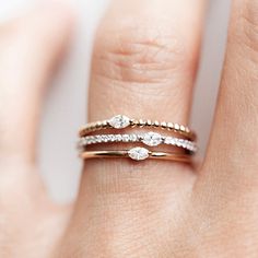 The Seed Marquise Stacker is the one on everyone's list! This ring features a dainty marquise diamond set east to west on a golden seed band. This piece truly has it all with unmatched texture and sparkle. Its design makes it versatile, allowing you to creatively incorporate it to any stack and its understated shine is brilliant. The Seed Marquise Stacker makes the perfect gift - for yourself or someone special! Stacker Rings, Pave Diamond Band, Gold Rings Stackable, Diamond Stacking Rings, Bar Stud Earrings, Butterfly Earrings Stud, Ring Stack, Marquise Diamond, Pear Diamond