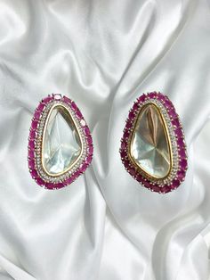 Beautiful vintage uncut polki stud earrings with silver diamond work and a modern luxurious look for any jewelry lover! The Pink stones are a beautiful pop of color with the bold diamond in the middle and these are the perfect statement earrings beautifully handmade for all occasions! These lightweight and elegant stud earrings is perfect for any bridesmaid, bride, sangeet or any occasion or event as a gift for any occasion as any one who loves jewelry will love this statement piece. It has beautiful colors that really make the set a statement piece. Product Details: * Earrings  Ready to Ship and available immediately if you place an order today! Fast Shipping US Customers receive your order within 5-7 business days. This is the actual product picture so no surprises (please note colors ma White Gemstone Party Earrings, Festive Wedding Earrings With Stone Setting, Diamond Gemstone Earrings In Temple Jewelry Style, Diamond Gemstone Temple Jewelry Earrings, Temple Jewelry Diamond Gemstone Earrings, Temple Style Diamond Gemstone Earrings, Bollywood Style Silver Diamond Earrings, Formal Earrings With Stone Setting In American Diamond, Silver American Diamond Earrings For Diwali