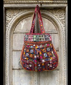 About bag  Indo-gypsy fusion, everyday use hand bag made from Banjara fabrics sourced from Vintage tribal costumes of regions of Rajastan and Gujarat. These are embellished with light catching coins, and intricate bead work tassels. Size - length 15 inches/ width 21 inches Company details:  Company name: Houseoftextile  Contact number: +919784447473  Email id: houseoftextile77@gmail.com  Shipping & custom : Delivery through one of the finest service providers : Skyway, Fedex, UPS  And DHL. Any l Multicolor Embroidery Shoulder Bag For Festivals, Festive Bags With Multicolor Embroidery And Mirror Work, Festive Shoulder Bag With Motifs For Festivals, Festive Handmade Bags For Everyday Use, Traditional Bags With Mirror Work For Festivals, Traditional Festive Shoulder Bag For Everyday Use, Festive Multicolor Shoulder Bag, Multicolor Hobo Bag For Festivals, Traditional Shoulder Bag With Mirror Work For Festivals