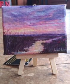 a small easel with a painting on it