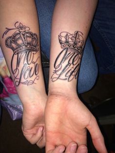 two people holding hands with matching tattoos on their arms, both showing the same name