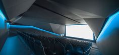 an empty theater with rows of seats facing the window