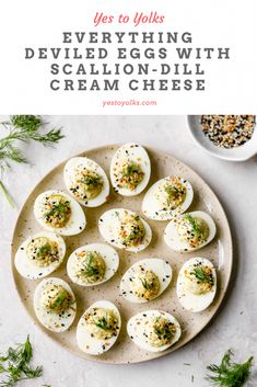 deviled eggs with scallion - dill cream cheese on a plate