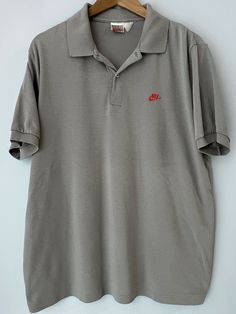 Vintage Gray Tag Nike Gray Polo Single Stitch Shirt XL. The Nike logo on the chest is embroidered red. Weight: 10.9oz Measurements, laying flat: Pit to pit: 24” Front length, collar to bottom: 26” Back length, top of collar to bottom: 30.5” Sleeve length from pit: 5.5” This item is used. This item has been washed using arm&hammer detergent. Since not all items are originally ours from new, throughout the life of this item, it may have come in contact with allergens. Colors are as close to exact Vintage Nike Cotton Tops, Nike Cotton Short Sleeve Polo Shirt, Nike Cotton Collared Tops, Nike Casual Collared Shirt, Casual Nike Collared Shirt, Nike Casual Short Sleeve Polo Shirt, Casual Nike Cotton Polo Shirt, Stitch Shirt, Vintage Polo