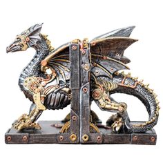 a metal dragon figurine sitting on top of a wooden stand