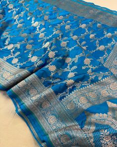 This is a very beautiful high quality mashru silk saree . All over zari motifs design with border . Saree length - 5.5 mtr. Blouse - 1 mtr. Dry clean only . Please note - color may be vary a little due to sunlight and photography . Please message us after purchasing in case you want fall and Pico done it not . No extra charges for fall and Pico but inform us . Blouse stitching is also available . Blue Katan Silk Designer Dupatta, Designer Blue Katan Silk Dupatta, Blue Katan Silk Dupatta For Designer Wear, Designer Blue Saree With Traditional Patterns, Blue Unstitched Katan Silk Saree, Blue Katan Silk Saree With Zari Work, Blue Katan Silk Saree With Zari Weaving, Designer Blue Katan Silk Saree, Blue Katan Silk Saree With Traditional Patterns