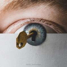 an eye with a key in it and the reflection of someone's eye is visible