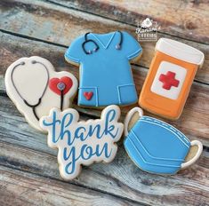 decorated cookies with the words thank you and nurse's hats are on a wooden table