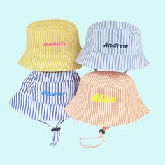 Candy striped baby sun hat for summer. This lovely personalised name baby bucket hat comes in yellow, orange, light blue or navy blue for baby boy or baby girl, infant to toddler 0-3 months, 3-6 months, 6-12 months and 12-18 months.   Perfect for sunny days, these baby beach hats with candy stripes have an adjustable toggle chin strap to ensure the hat stays on even on breezy days and the quick release safety fastening gives extra peace of mind.   The summer baby hats have a 4cm wide brim for go Cute Yellow Summer Sun Hat, Fun White Cotton Sun Hat, White Bucket Hat For Summer Playtime, Multicolor Summer Hats For Playtime, Playful White Cotton Sun Hat, Cute White Cotton Bucket Hat, Yellow Summer Cotton Bucket Hat, Yellow Cotton Summer Bucket Hat, Playful Cotton Bucket Hat For Playtime