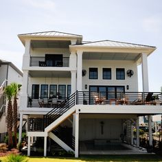 a two story house with balconies on the second floor