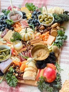 a table topped with lots of different types of cheeses and crackers on top of it