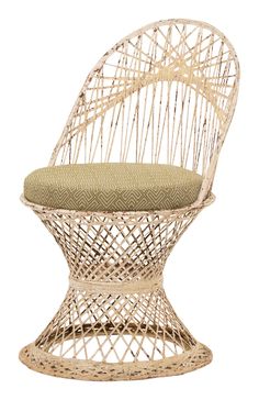 a white wicker chair with a green cushion on the seat and backrests