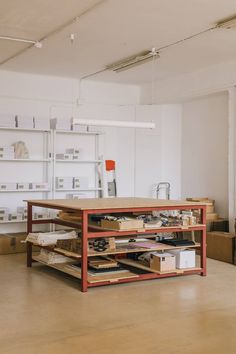 an empty room with several shelves and boxes on the floor in front of it,