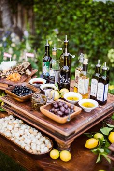 an outdoor picnic with food and wine on the table in front of it that says food