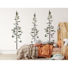 the wall decals in this children's room are decorated with pine trees and leaves