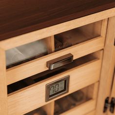 a wooden cabinet with glass doors and drawers