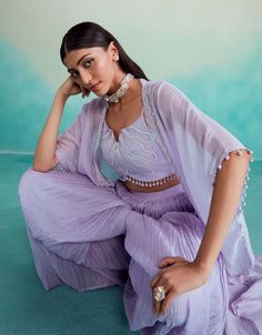 Introducing the serenity jacket set in digital lavender - a stunning ensemble crafted with love from chanderi fabric. Featuring a hand-embroidered crop top and jacket adorned with exquisite mirror work, it's perfect for making a stylish statement on any occasion. Paired with a micropleated sharara, this set offers elegance and comfort in one stunning Spring Georgette Set With Mirror Work, Spring Wedding Set With Gota Work, Spring Wedding Sets With Gota Work, Spring Chanderi Sharara With Dori Work, Spring Sharara With Dori Work In Chanderi, Spring Wedding Palazzo Set With Mirror Work, Spring Sharara With Mirror Work In Chanderi, Spring Saree Set With Mirror Work, Spring Anarkali Sets With Mirror Work