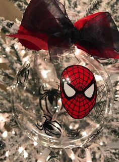 a spiderman ornament hanging from a christmas tree