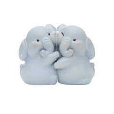 two white elephants with their trunks touching each other