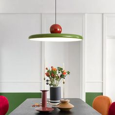 a dining room table with vases and flowers on it