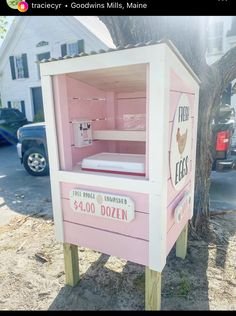 a pink and white wooden box shaped like a bed in the shape of a doll house