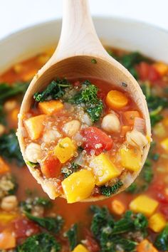 a wooden spoon full of vegetable quinoa soup